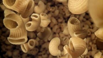 Dry pasta flies down. Filmed on a high-speed camera at 1000 fps. High quality FullHD footage video