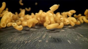 Dry pasta falls on the table. Filmed on a high-speed camera at 1000 fps. High quality FullHD footage video