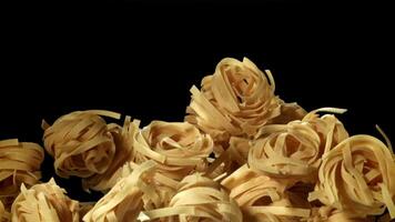 The tagliatelle pasta flies up. Filmed on a high-speed camera at 1000 fps. High quality FullHD footage video