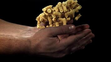 Dry pasta flies up and falls in your hands. Filmed on a high-speed camera at 1000 fps. High quality FullHD footage video