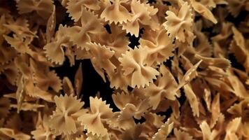 Farfale pasta flies in and falls. Filmed on a high-speed camera at 1000 fps. High quality FullHD footage video