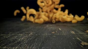 Dry pasta falls on the table. Filmed on a high-speed camera at 1000 fps. High quality FullHD footage video