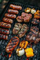 Grilling a delicious assortment of sausages, steaks, and vegetables during a summer barbecue photo