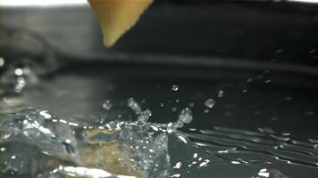 The pasta falls into the boiling water with splashes. Filmed on a high-speed camera at 1000 fps. High quality FullHD footage video
