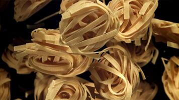 The tagliatelle pasta flies up. Filmed on a high-speed camera at 1000 fps. High quality FullHD footage video