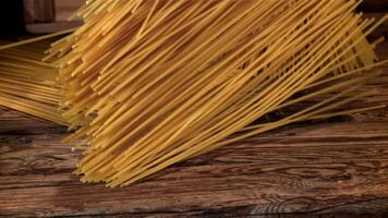 Spaghetti falling on a wooden table. Filmed on a high-speed camera at 1000 fps. High quality FullHD footage video