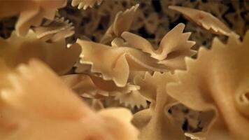 Farfale pasta flies in and falls. Filmed on a high-speed camera at 1000 fps. High quality FullHD footage video