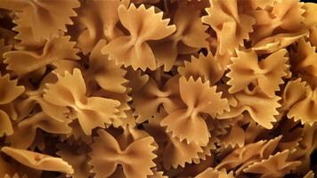 Farfale pasta flies in and falls. Filmed on a high-speed camera at 1000 fps. High quality FullHD footage video