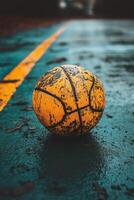Basketball covered in raindrops against a blurred urban background during a rainy day photo