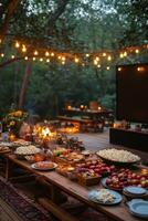 Cozy outdoor cinema setup with fire pit in an autumn forest cabin during the evening photo