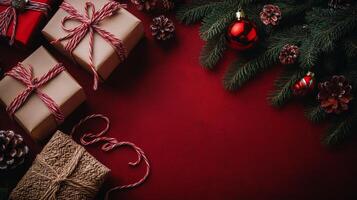 Festive holiday gifts arranged with pinecones and ornaments on a red background photo