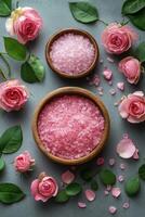 Beautiful arrangement of pink roses and salt in a bowl with petals on a textured gray background photo