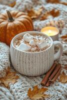 Cozy autumn scene with hot chocolate, marshmallows, and pumpkin photo