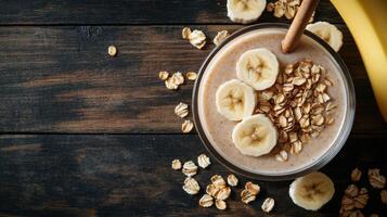 Banana smoothie with oats and honey on a wooden table photo
