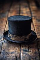 A classic black top hat placed elegantly on a rustic wooden table in soft lighting photo