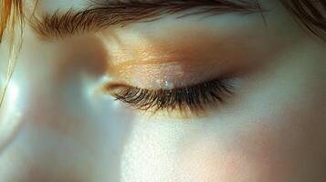 Close-up of a persons eye with soft makeup under natural light photo