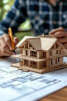 Architectural model creation with detailed blueprints in a bright workspace during the day photo