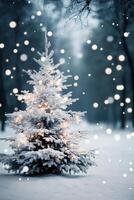 A beautifully lit, snow-covered Christmas tree in a serene winter landscape with falling snowflakes photo