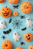 Colorful Halloween decorations with pumpkins, ghosts, and bats on a blue background photo
