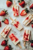Delicious strawberry yogurt popsicles on a marble countertop surrounded by fresh strawberries photo