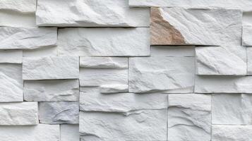 Textured white stone wall tiles arranged in an organized pattern for modern interior design photo
