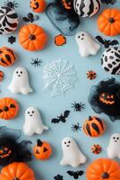 Colorful Halloween decorations with pumpkins, ghosts, and bats on a blue background photo
