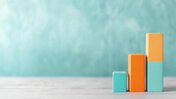 Colorful bar graph representing growth on a minimalist desk with soft blue background photo