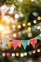 Colorful festive bunting adorned with lights in a park during a warm summer evening photo