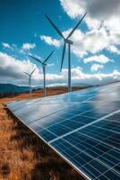 Wind turbines and solar panels harnessing renewable energy in a scenic landscape at sunset photo