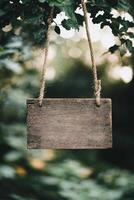 Rustic wooden sign hanging in a forest with blurred greenery in the background photo