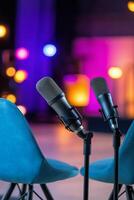 Colorful microphones and chairs set up for a podcast recording in a vibrant studio environment photo