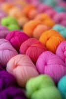 Colorful collection of yarn balls arranged in rows showcasing vibrant hues for crafting photo