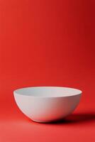 Simple white bowl on a vibrant red background capturing modern minimalism photo