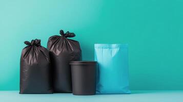 Black and teal garbage bags lined up against a solid turquoise background in a clean setting photo