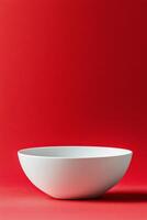 Simple white bowl on a vibrant red background capturing modern minimalism photo