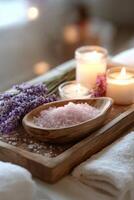 Relaxing spa setting with lavender, candles, and bath salts arranged on a wooden tray photo