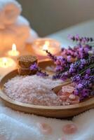 Relaxing spa setting with lavender, candles, and bath salts arranged on a wooden tray photo