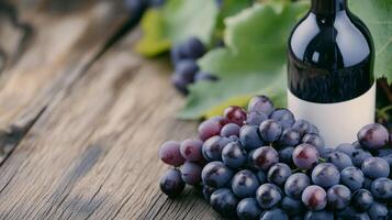 Grapes and wine bottle resting on a rustic wooden surface surrounded by green leaves photo