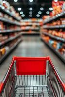 Shopping cart in a grocery store aisle filled with colorful product packages during the day photo