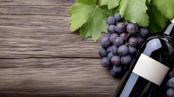 Grapes and wine bottle resting on a rustic wooden surface surrounded by green leaves photo