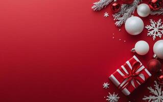 Festive arrangement of Christmas ornaments, a gift box, and snowflakes on a vibrant red background photo
