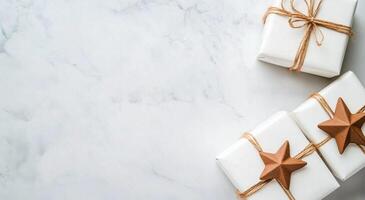 Celebratory wrapped gifts with stars and decorative elements on a marble surface photo