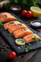 Fresh salmon fillets garnished with lemon slices and herbs on a rustic wooden table photo