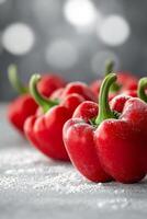 Fresh red bell peppers arranged on a kitchen counter ready for a cooking session or meal prep photo