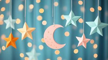 Decorated ceiling with paper stars and moon hanging against a teal backdrop with lights photo