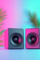 Two black speakers placed on a table with vibrant colored bokeh background at night photo