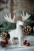 A decorative white moose figurine amidst festive holiday decorations and glowing lights photo