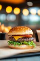 Delicious sesame seed burger with lettuce, tomato, and fries in a casual dining setting photo