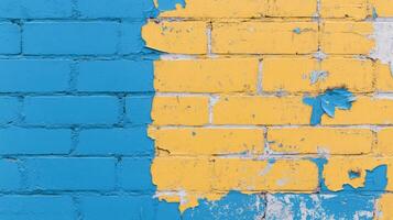 Two-tone brick wall divided into blue and yellow sections with peeling paint in urban setting photo