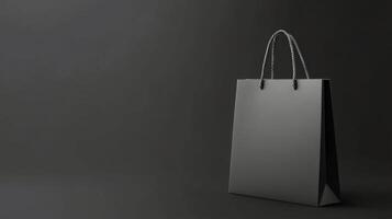 Simple black shopping bag displayed on a dark background highlighting its elegant shape photo